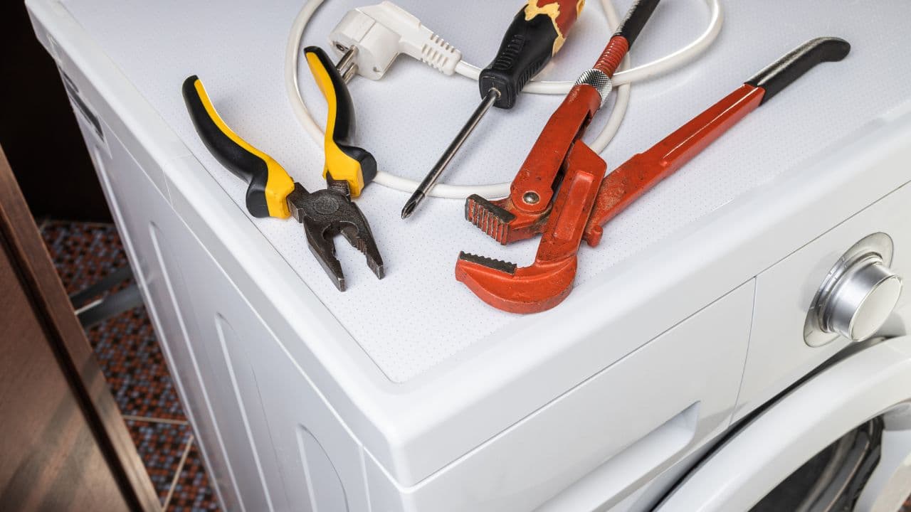 Appliance repair technician at work